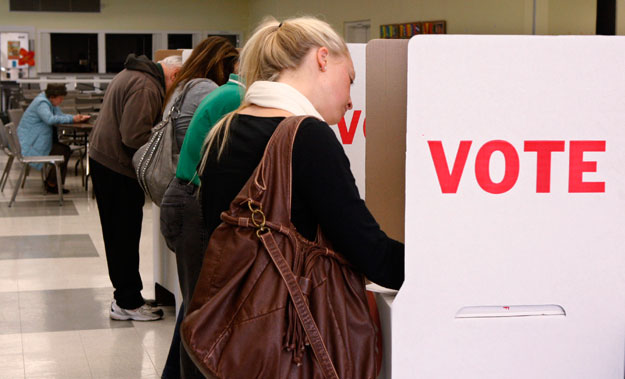 Sarah Amis, right, votes in the general elections this year in Oklahoma City. Women voters largely decided the outcomes of many congressional races, as well as the presidential election. (AP/Sue Ogrocki)