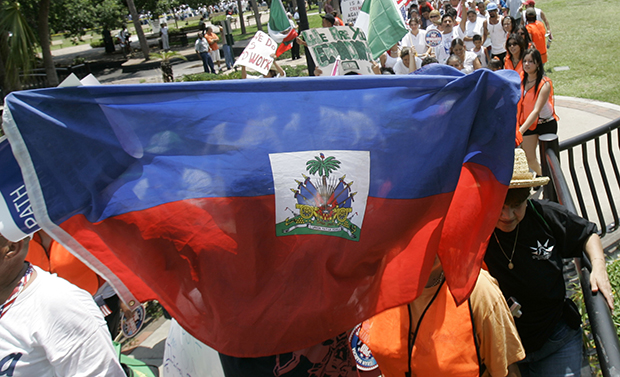 A protester holds up a Haitian flag during a march for immigration reform in Orlando, Florida. (AP/John Raoux)