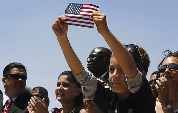 Audience members listen to President Barack Obama speak about immigration reform at Chamizal National Memorial Park in El Paso, Texas, on May 10, 2011. (AP/Charles Dharapak)