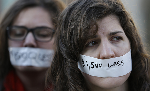 A silent protester wears a sticker to signify loss in wages from the 
