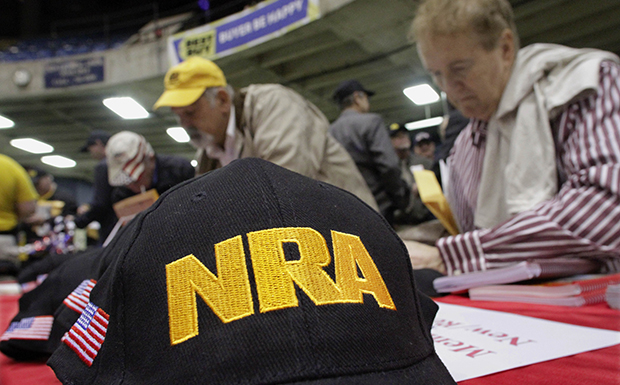 Illinois gun owners and supporters fill out NRA applications while participating in an Illinois Gun Owners Lobby Day convention before marching to the Illinois State Capitol, Wednesday, March 7, 2012, in Springfield, Illinois. (AP/Seth Perlman)