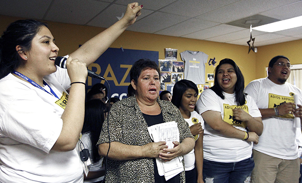 Grecia Lima, left, cheers as Maria Durand, second from left, brings her early voting ballot as they join members of Promise Arizona in Action in announcing their voter registration drive with Latino youth at a news conference, Thursday, October 25, 2012, in Phoenix. (AP/Ross D. Franklin)
