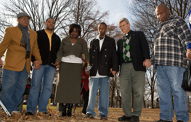 Father Bob Gettinger, second right, leads a prayer for those killed by gun violence and for the safety of the community as people gather in St. Louis, Missouri, on Monday, November 23, 2009, one of among more than 20 other U.S. cities participating in the National Day of Outrage, a nationwide call to end violence in urban communities. (AP/Boza Ivanovic)