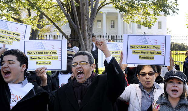 Gustavo Torres, director, Casa in Action, center, and others chant during a rally of immigration rights organizations in front of the White House in Washington, Thursday, November 8, 2012, calling on President Barack Obama to fulfill his promise of passing comprehensive immigration reform. (AP/Cliff Owen)