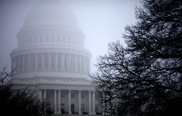 Fog obscures the Capitol dome on Capitol Hill in Washington on Monday, December 10, 2012. The resolution of the fiscal showdown allowed the economy to keep growing in January, but more needs to be done to help the economy. (AP/J. Scott Applewhite)