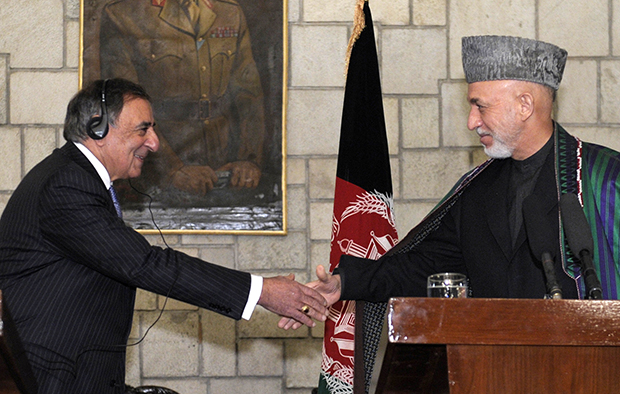 U.S. Defense Secretary Leon Panetta, left, shakes hands with Afghan President Hamid Karzai, right, during their joint press conference at the Presidential Palace in Kabul, Afghanistan, Thursday, December 13, 2012. (AP/Susan Walsh)