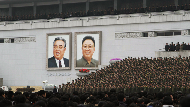 North Korean soldiers stand near the portraits of former North Korean leaders Kim Il Sung and Kim Jong Il while attending a rally in celebration of the country's recent nuclear test at Kim Il Sung Square on February 14, 2013, in Pyongyang, North Korea. (AP/ Jon Chol Jin)