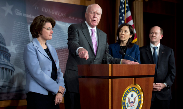 Senate Judiciary Committee Chairman Patrick Leahy (D-VT), second from left, the lead author of the Violence Against Women Reauthorization Act, joined by, from left, Sens. Amy Klobuchar (D-MN), Maria Cantwell (D-WA), and Christopher Coons (D-DE), speaks during a news conference on Capitol Hill in Washington, following the Senate’s passage of the Violence Against Women Reauthorization Act, February 12, 2013. (AP/Manuel Balce Ceneta)