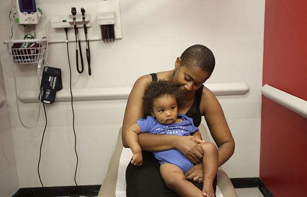 Tiffany Ashe prepares her son Aaron Ashe for his check-up at the William F. Ryan Community Health Center in New York, Wednesday, June 27, 2012. (AP/Seth Wenig)