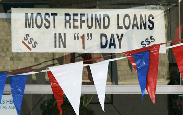 A sign promoting loans for instant tax refunds is displayed in a window in Little Rock, Arkansas, Tuesday, January 26, 2010. (AP/Danny Johnston)