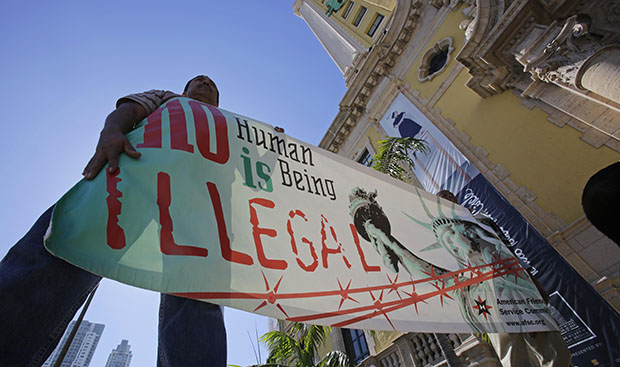 Immigration reform activists hold a sign in front of Freedom Tower in downtown Miami, Florida, Monday, January 28, 2013. (AP/Alan Diaz)
