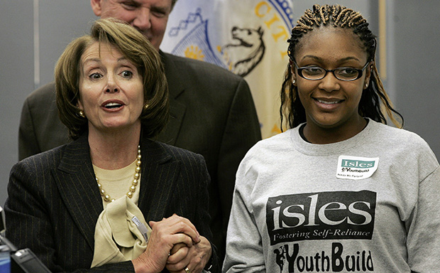 Then-Speaker of the House of Representatives Nancy Pelosi (D-CA) holds the hand of Nikita McFarland, a student at Isles YouthBuild Institute, Friday, February 29, 2008, in Trenton, New Jersey. (AP/Mel Evans)