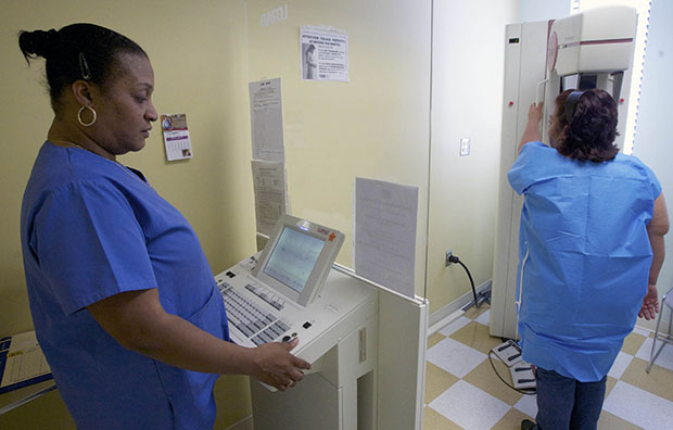 Detection lead mammographer Toborcia Bedgood performs an advanced-imaging screening that promotes early detection of breast cancer for low-income patient Alicia Maldonado at The Elizabeth Center for Cancer Detection in Los Angeles, May 6, 2010. (AP/Damian Dovarganes)