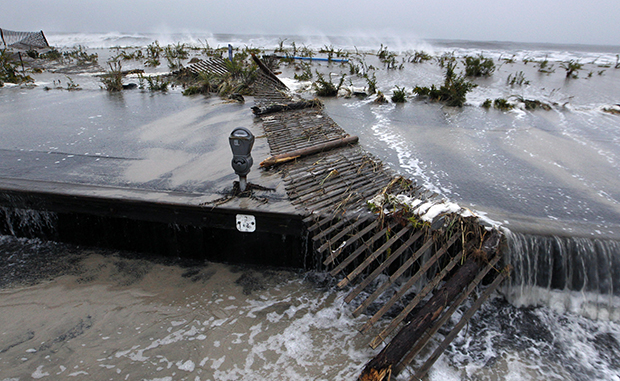 Rough surf of the Atlantic Ocean breaks over the beach and across Beach Avenue, Monday, October 29, 2012, in Cape May, New Jersey, as high tide and superstorm Sandy begin to arrive. (AP/Mel Evans)