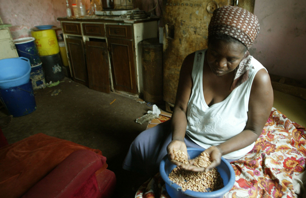 Faustine Janjira prepares food at her home in Highfields, a high-density suburb of Harare, Zimbabwe, October 17, 2006. Janjira, who lives with her sisters and their 10 children in a two-room house, struggles to feed the big family as only one member of the family works. (AP/Tsvangirayi Mukwazhi)