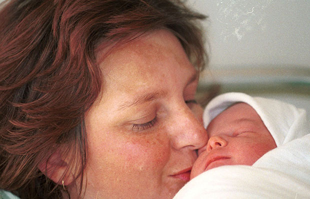Fatima Nevic kisses her baby boy after a seven-hour labor in a Sarajevo hospital. (AP/Sava Radovanovic)