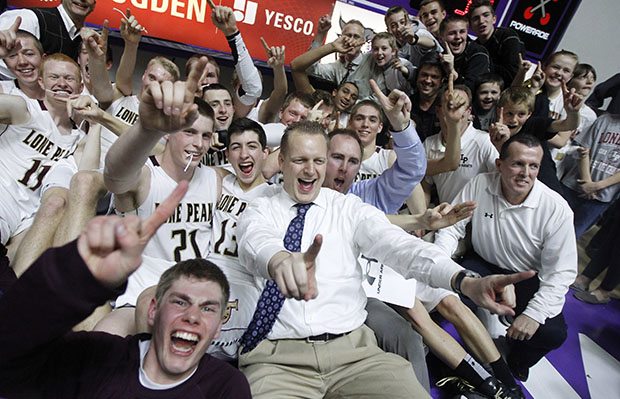 Lone Peak coach Quincy Lewis, center, celebrates with his team after Lone Peak defeated Alta 72–39 in the state Class 5A boys basketball championship, Saturday, March 2, 2013, in Ogden, Utah. (AP/Rick Bowmer)