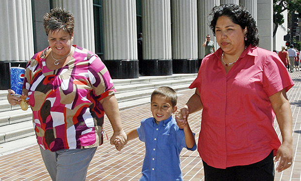 Guadalupe Benitez, right, walks with her partner Joanne Clark, left, and their son Gabriel Clark-Benitez, center, after a news conference held at the Hall of Justice in downtown San Diego, Monday, August 18, 2008. The California Supreme Court ruled that Benitez, a lesbian, was unfairly denied a common infertility treatment  by doctors at the North Coast Women's Care Medical Group based on their religious beliefs. (AP/Denis Poroy)