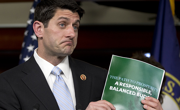 House Budget Committee Chairman Paul Ryan (R-WI) holds up a copy of the FY 2014 budget resolution as he speaks during a news conference on Capitol Hill in Washington, Tuesday, March 12, 2013. (AP/Carolyn Kaster)