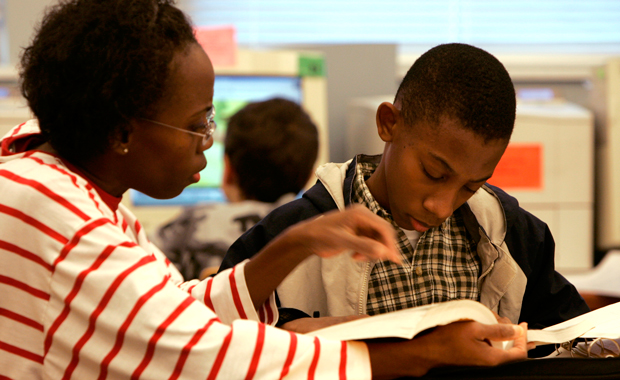Denise Armstrong helps her son Joseph, 13, with his schoolwork in a library in Richmond, Virginia. (AP/Steve Helber)