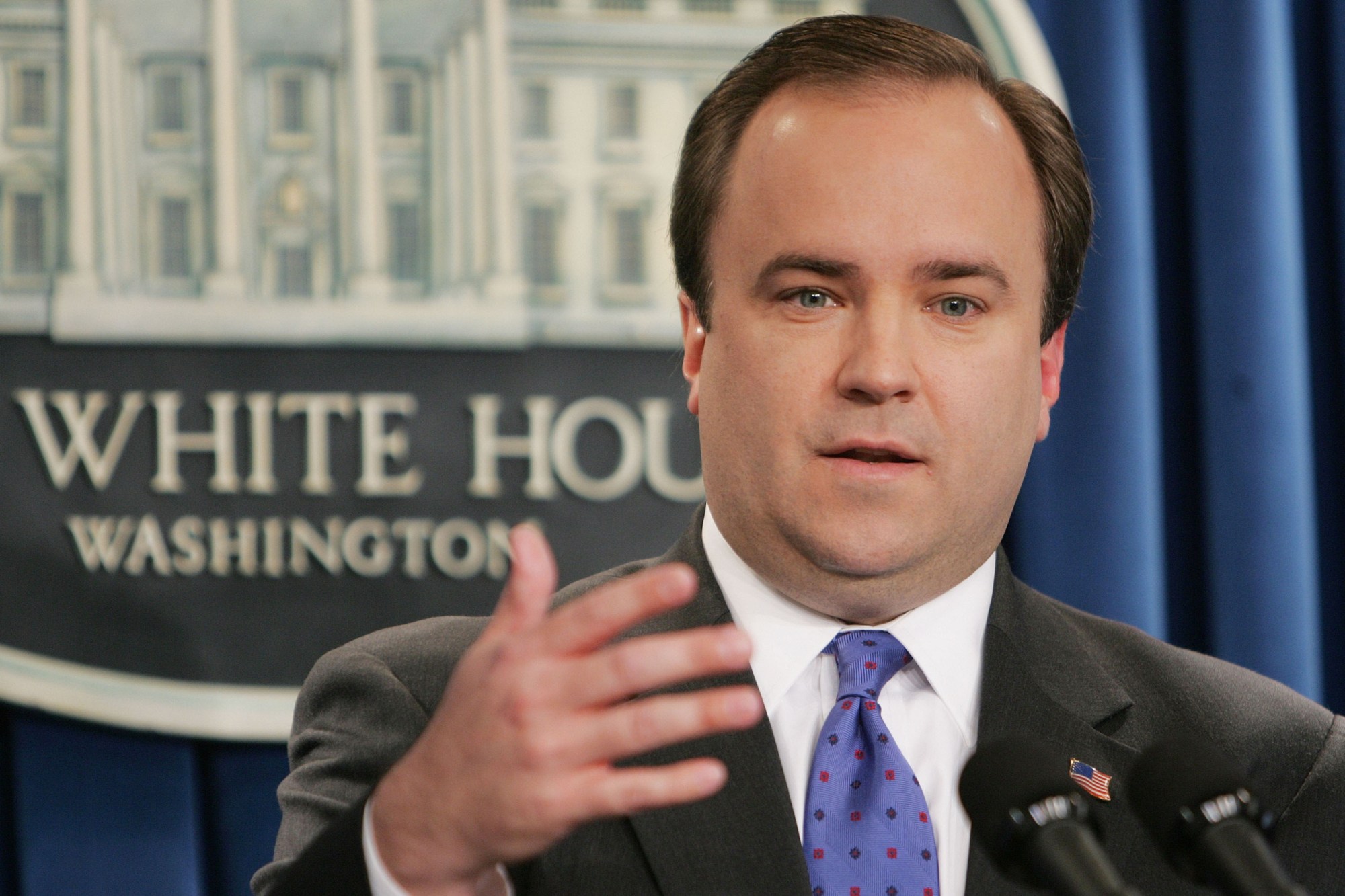 In this December 13, 2005, file photo, then-White House Press Secretary Scott McClellan under President George W. Bush adresses questions about the Iraq war from members of the media. (AP/Ron Edmonds)