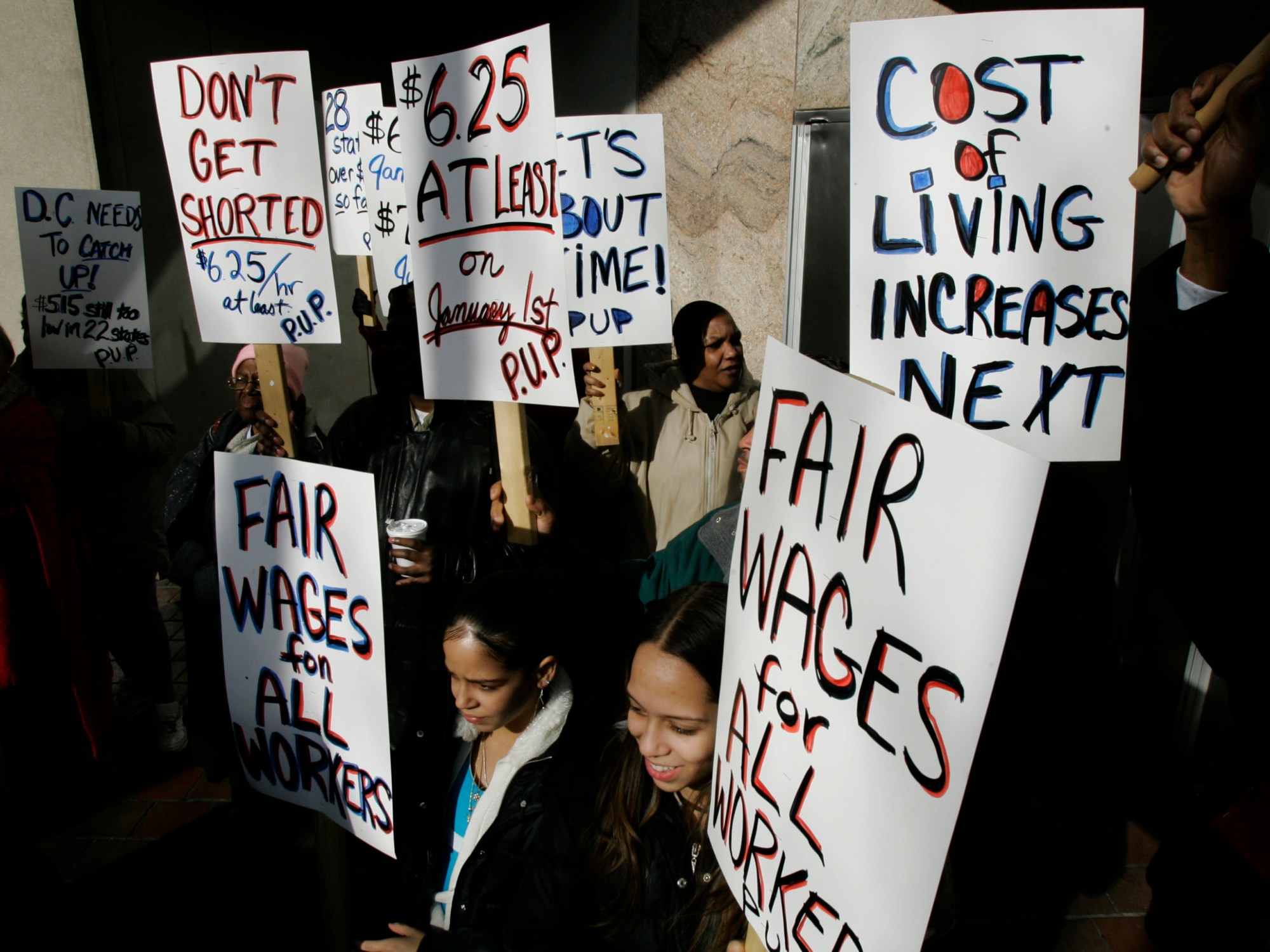 Supporters of Pennsylvania's new law increasing the minimum wage rally in Philadelphia. If women were paid a living wage, the gender-based wage gap would decrease in growing industries. (AP/Matt Rourke)
