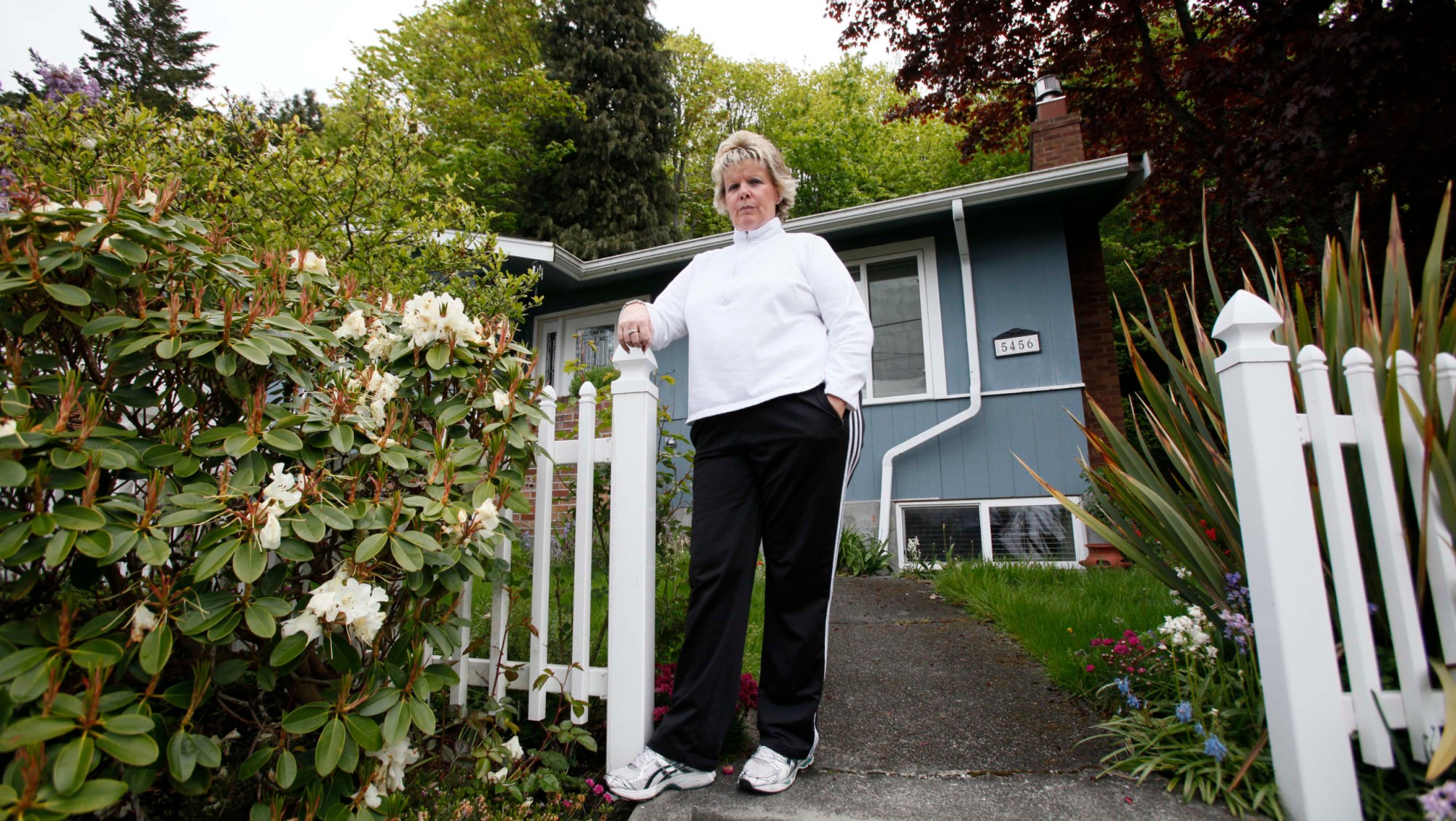 Rose Inman stands on the walkway at the home she is about to lose in Seattle. Inman has been laid-off twice and can no longer afford her $3,100 monthly mortgage payments (AP/ Elaine Thompson)