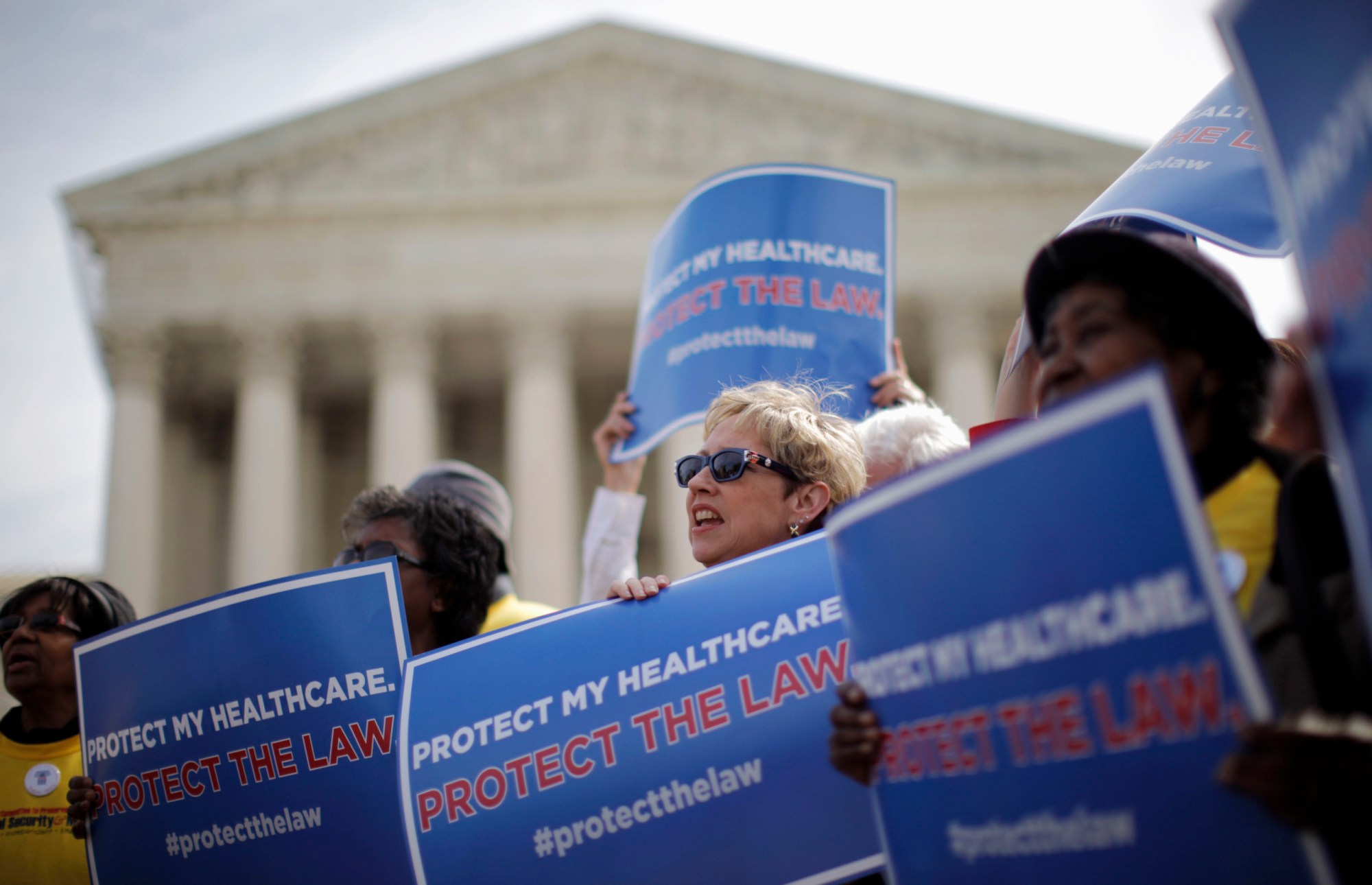 Supporters of health care reform rally in front of the Supreme Court in Washington on the final day of arguments regarding the health care law signed by President Barack Obama. (AP/ Charles Dharapak)