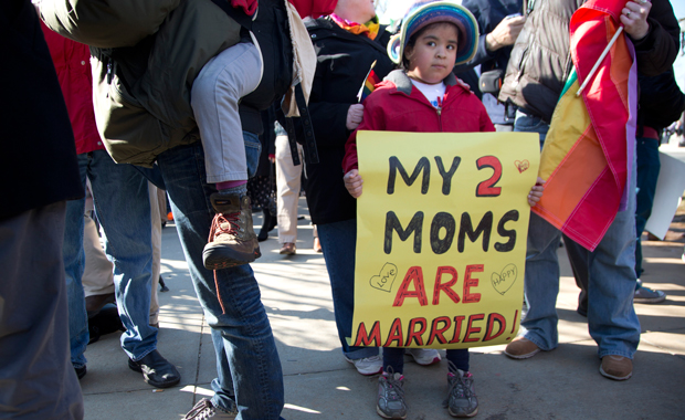 Gabriela Fore, 6, of Upper Darby, Pennsylvania, holds a sign with her moms in front of the Supreme Court in Washington, Wednesday, March 27, 2013 as the court heard arguments on the Defense of Marriage Act. (AP/Carolyn Kaster)