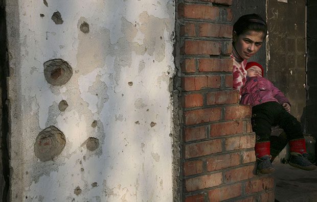 A Chechen girl holds her brother on the balcony of a flat in a destroyed house in Grozny, Chechnya, March 15, 2007. (AP/Musa Sadulayev)