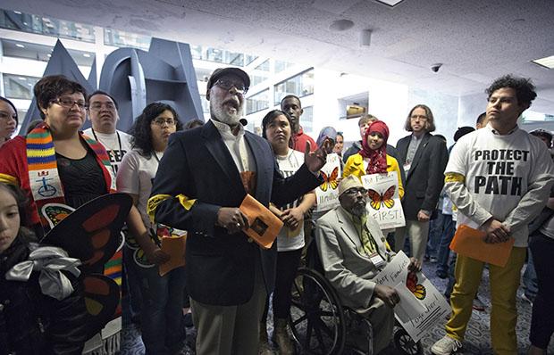 Rev. Eugene Barnes of Champaign, Illinois, and president of Illinois People's Action, joins immigration advocates gathered outside the Senate Judiciary Committee hearing on immigration reform in the Senate Hart Office Building on Capitol Hill in Washington, Monday, April 22, 2013, to recount personal stories of how they were affected by being undocumented in America. (AP/J. Scott Applewhite)