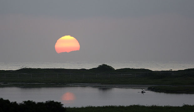 The sun rises over the Pacific Ocean in Kailua, Hawaii in December 2009. (AP/Alex Brandon)