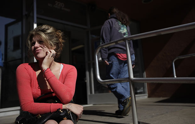 A woman who only gave her first name, Ally, and said it was her first time applying for supplemental nutrition assistance waits to be called for an appointment at a city building in El Cajon, California, in 2010. Cuts to the Supplemental Nutrition Assistance Program proposed by the House Republican budget could affect up to 13 million people and cost the economy hundreds of thousands of jobs. (AP/Gregory Bull)