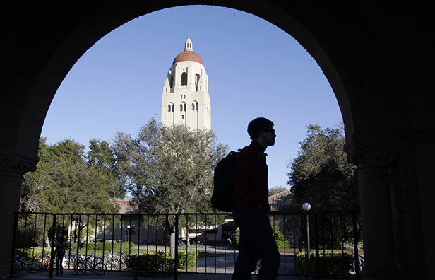 A Stanford University student walks in front of Hoover Tower on the Stanford University campus in Palo Alto, California, February 15, 2012. The rise in student-loan debt could have a negative impact on the housing market, the broader economy, and Americans' future financial security. (AP/Paul Sakuma)