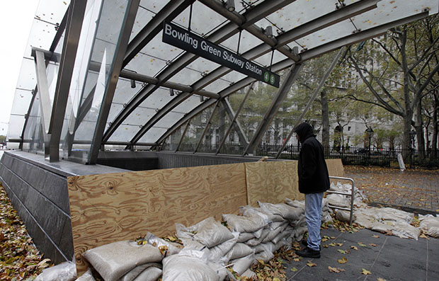 A man peers into the closed Bowling Green Subway Station in New York, October 30, 2012, after Superstorm Sandy hit the East Coast. (AP/Richard Drew)