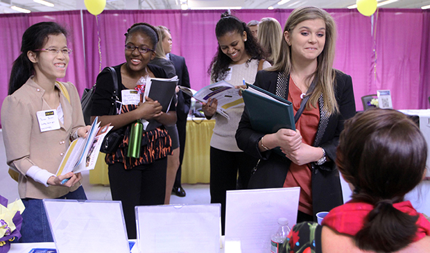 Martina Ryberg, right, of Plymouth State University talks with Tara Rossetti of On Call International during a job fair for college students, Wednesday, April 4, 2012, in Manchester, New Hampshire. (AP/Jim Cole)