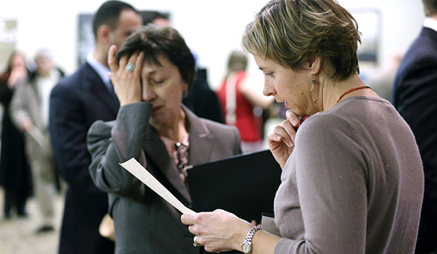 In this Monday, February 25, 2013, photo, Ann Oganesian, left, of Newton, Massachusetts, pauses as she speaks with a State Department employee about job opportunities with the federal government during a job fair in Boston. (AP/Michael Dwyer)
