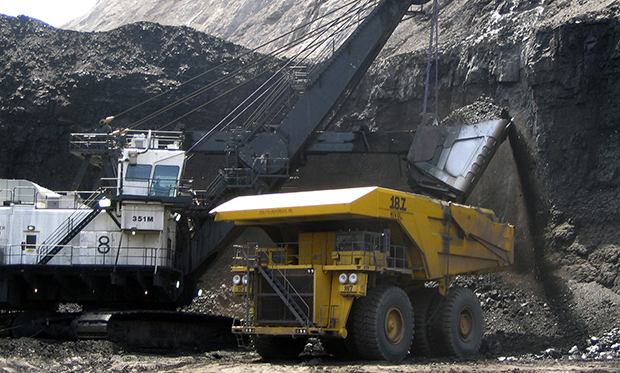 A shovel prepares to dump a load of coal into a 320-ton truck at the Black Thunder Mine, located within Wyoming's Powder River Basin, the nation's most productive coal region. (AP/Matthew Brown)