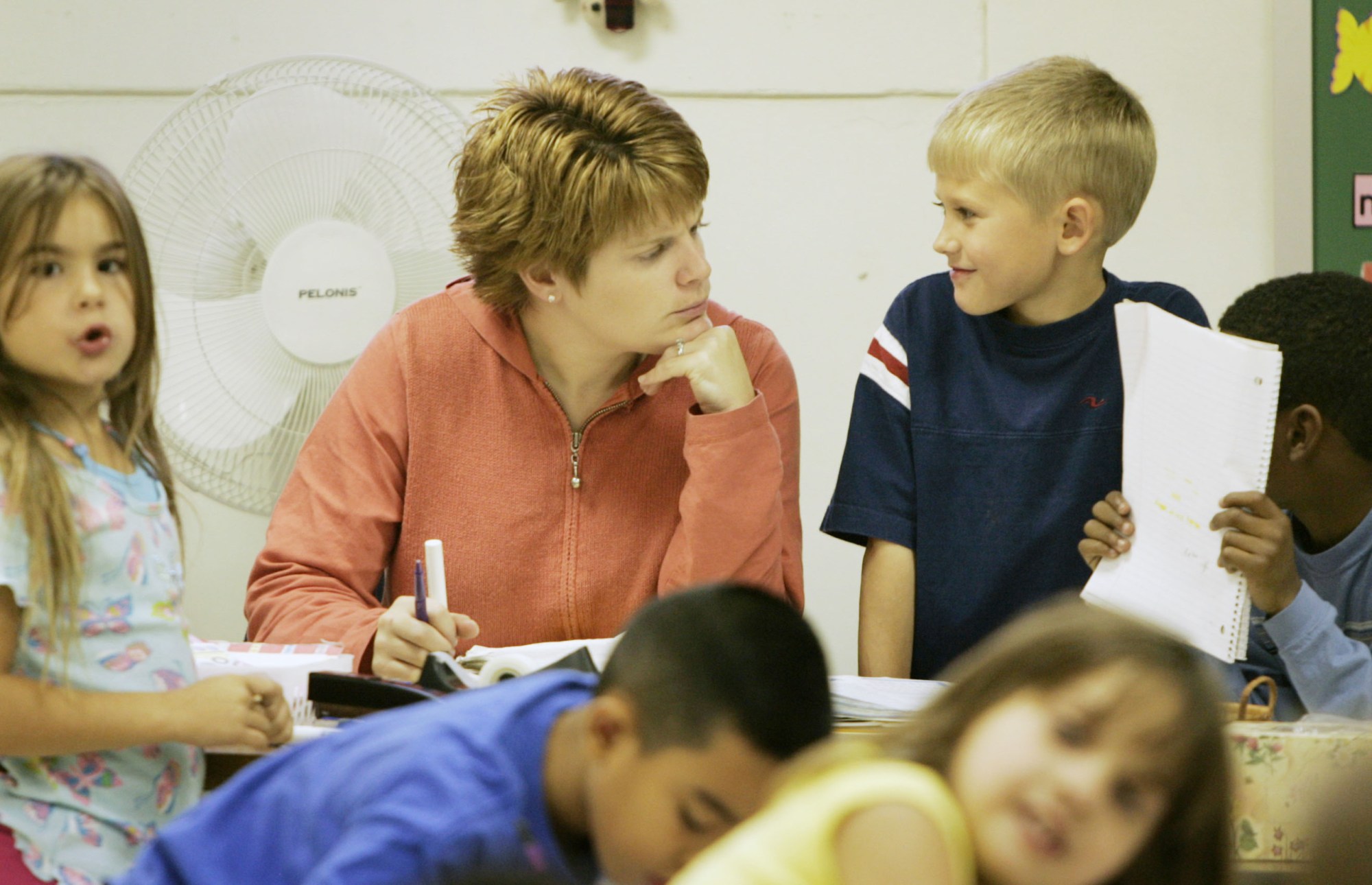 Third-grade teacher Cindy Rasmussen works with students at Ware Elementary School at Fort Riley, Kansas. Cuts in Impact Aid funding for education will hurt schools on military bases. (AP/Orlin Wagner)