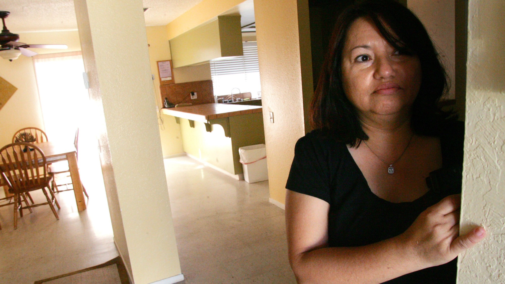 Norma Alvarez looks out the door of a shuttered domestic abuse shelter that was forced to close due to cuts in government funding. (AP/Gary Kazanjian)