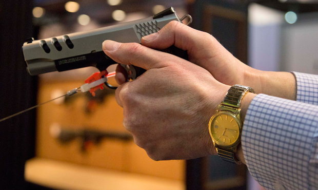 The Smith & Wesson .45 caliber M1911 pistol is held at the 35th annual SHOT Show, Tuesday, January 15, 2013, in Las Vegas. (AP/Julie Jacobson)