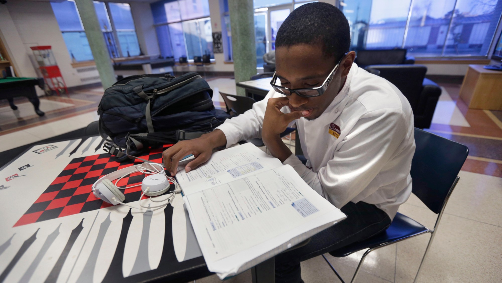 Xavier University student Triton Brown studies in a common area on campus before going to one of his part-time jobs in New Orleans. (AP/Gerald Herbert)
