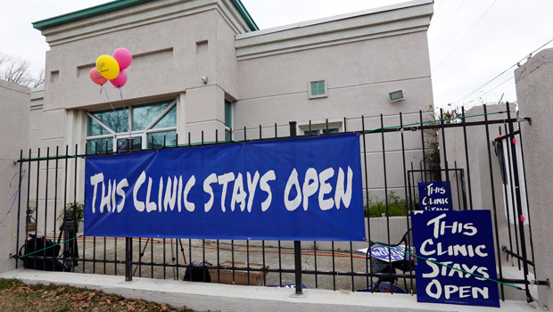 Signs placed by abortion-rights activists are displayed on the front security gating of the Jackson Women's Health Organization Inc. in Jackson, Mississippi, Tuesday, January 22, 2013. (AP/Rogelio V. Solis)