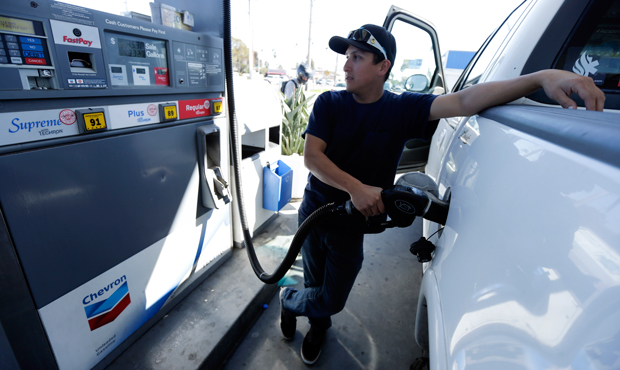 Chris King fills up his truck at a gas station displaying a price of $4.59 for a gallon of self-service regular gas on Friday, February 22, 2013, in San Diego, California. (AP/Gregory Bull)