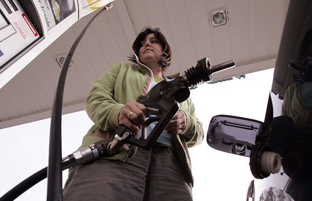 A customer pumps gas at a gas station in Menlo Park, California. Even though many middle-class programs are facing cuts, the big five oil companies continue to enjoy huge profits and tax breaks. (AP/Paul Sakuma)