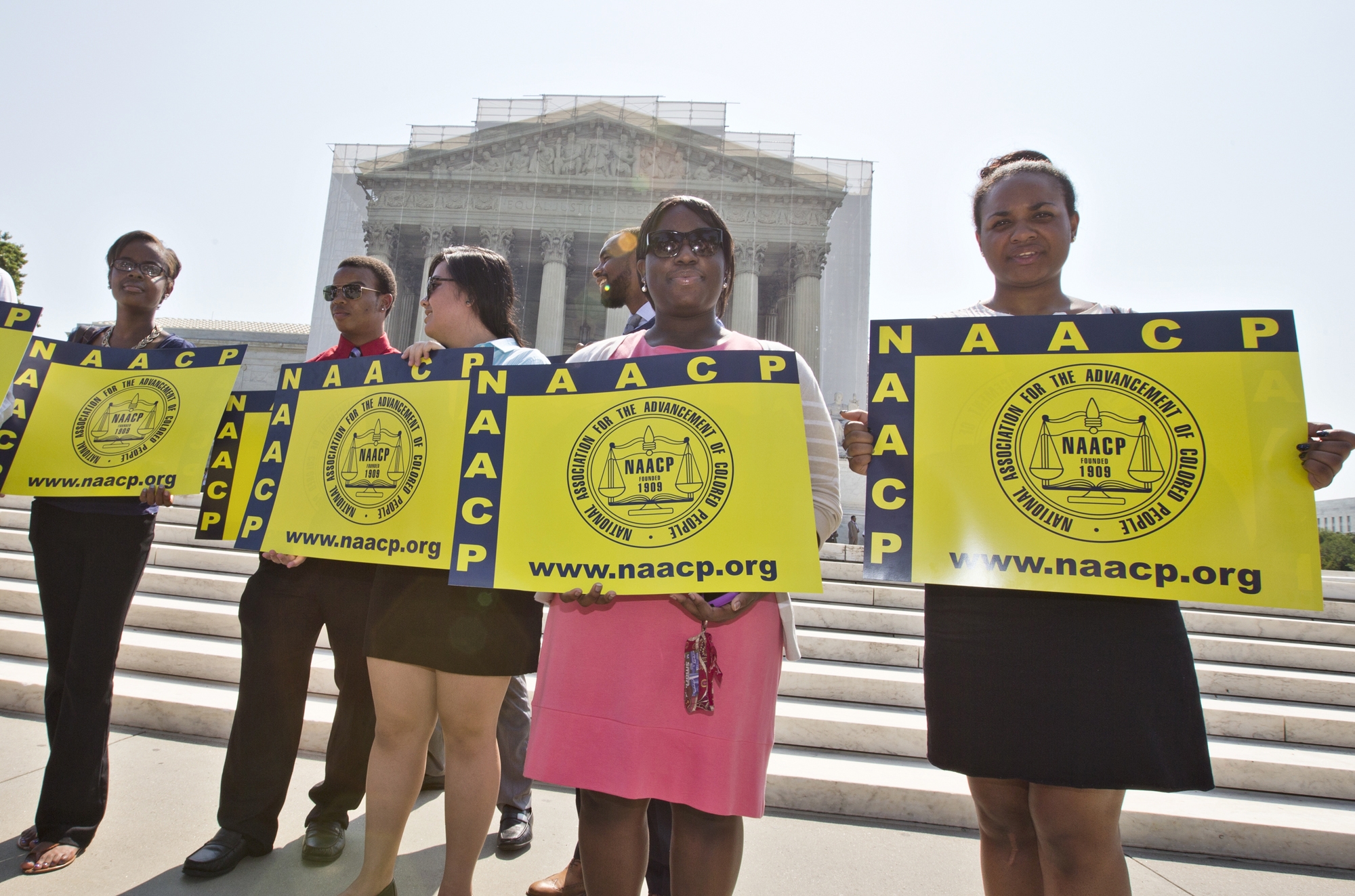 Representatives from the NAACP Legal Defense Fund stand outside the Supreme Court in Washington, on Tuesday, June 25, as the Supreme Court considers <em>Shelby County v. Holder</em>, a voting rights case in Alabama. (AP/J. Scott Applewhite)
