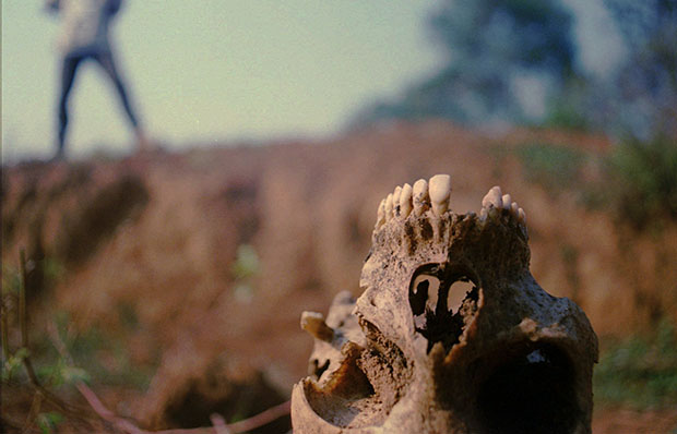 A skull lies near the bottom of a recently excavated mass grave at the site of the 1994 Nyamata, Rwanda, Roman Catholic Church massacre, Wednesday, August 6, 1997. (AP/Brennan Linsley)