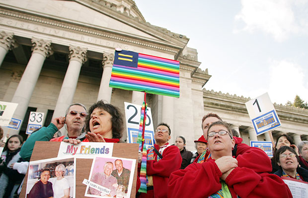 Linda Baker, foreground left, of Renton, Washington, and Kim Nuesse, right, of Kelso, Washington, join others on the Capitol steps during a rally in support of legislation to protect gay and lesbian citizens from discrimination in housing, employment, and insurance, January 23, 2006, in Olympia, Washington. (AP/John Froschauer)