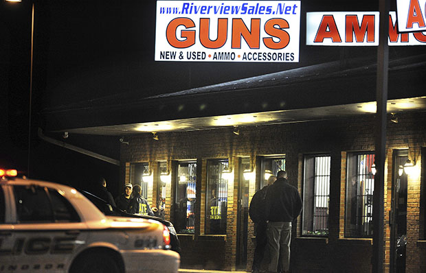 Law-enforcement officials stand outside Riverview Gun Sales, December 20, 2012, as authorities raid the store in East Windsor, Connecticut. (AP/Jessica Hill)