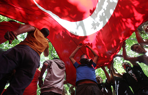 High school students hold up a Turkish flag during a protest at Gezi Park in Taksim Square in Istanbul, Turkey, Monday, June 3, 2013. (AP/Thanassis Stavrakis)